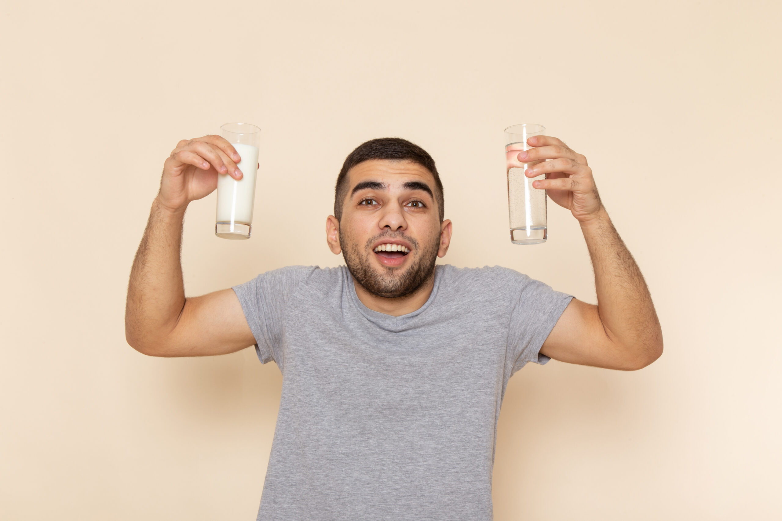 front-view-young-male-grey-t-shirt-holding-glass-water-milk-beige