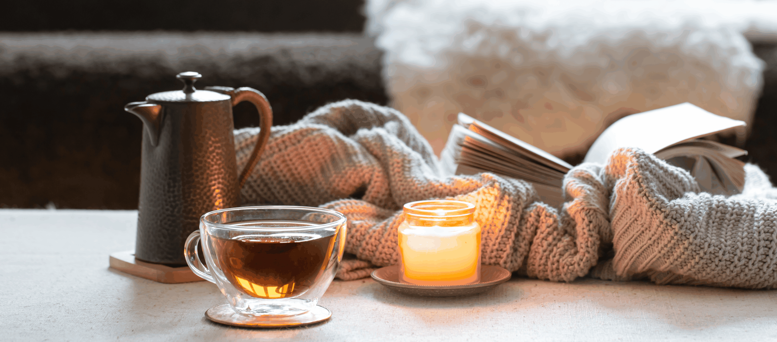 glass-cup-tea-teapot-candle-book-with-knitted-element-concept-home-comfort-warmth