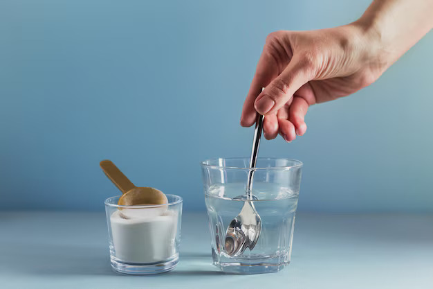 glass-with-collagen-dissolved-water-collagen-protein-powder-light-blue-surface-woman-s-hand-holds-spoon-healthy-lifestyle-concept_111869-3053