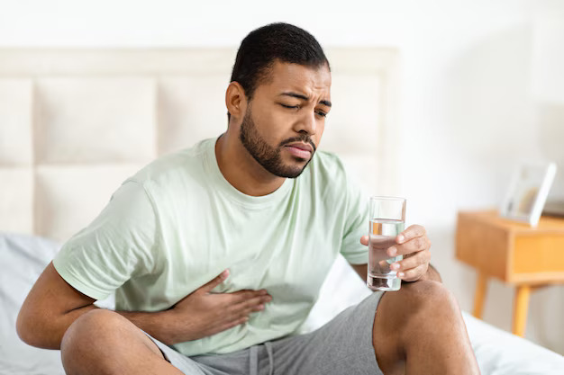 man-bed-holding-stomach-glass_116547-103830