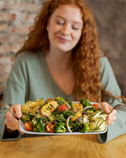 medium-shot-woman-holding-plate-with-food_23-2148899029