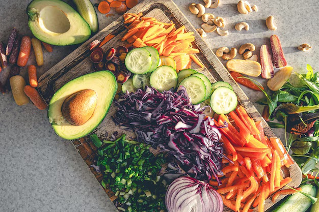 sliced-fresh-vegetables-cutting-board-kitchen-table-top-view_169016-49181