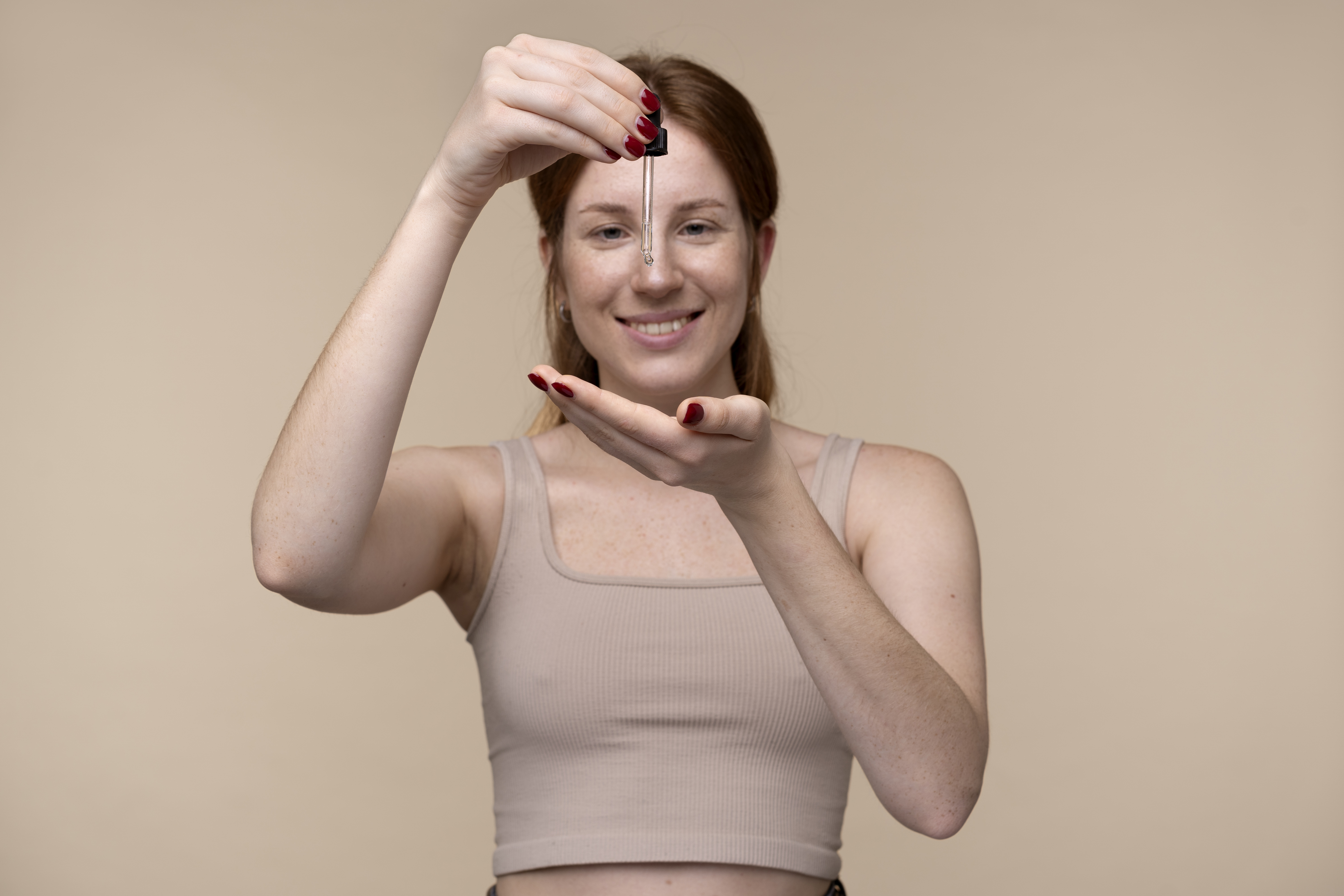 portrait-young-woman-pouring-serum-her-hand