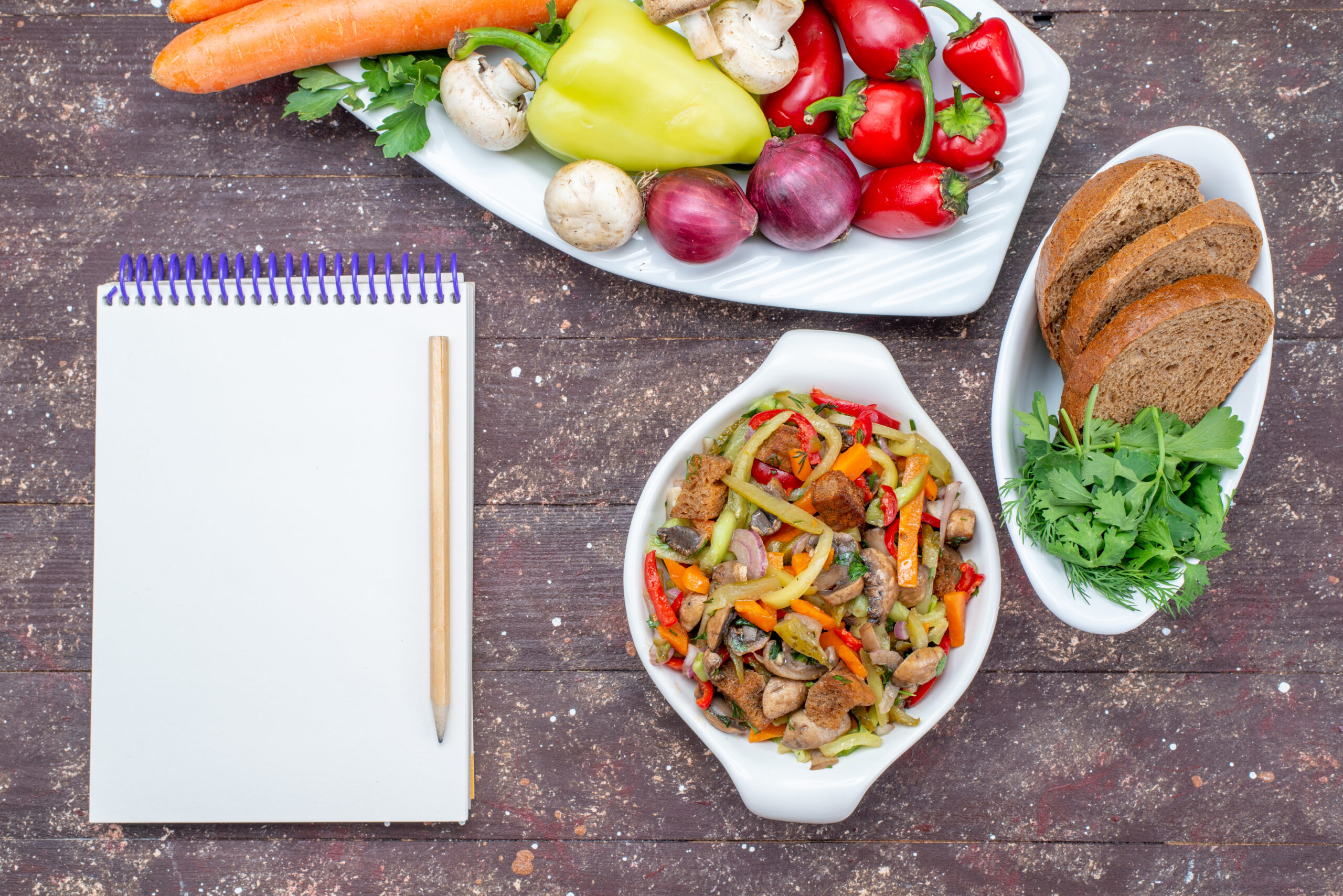 top-view-fresh-vegetables-with-mushrooms-inside-plate-with-bread-loafs-greens-notepad-brown-vegetable-food-meal-mushroom (1)